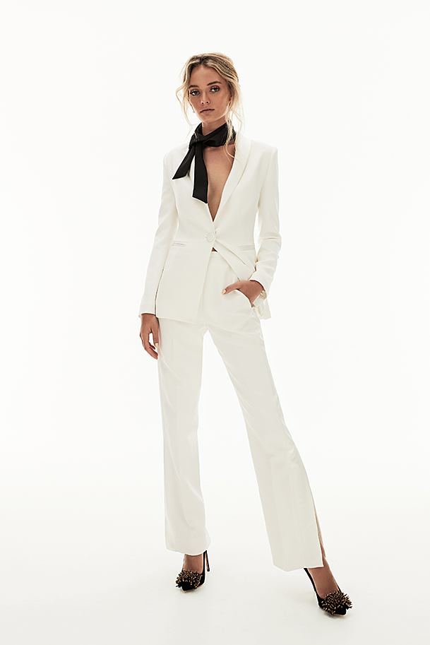 Silk crepe tuxedo with satin lapels, pockets, and side stripe on split-leg trouser.